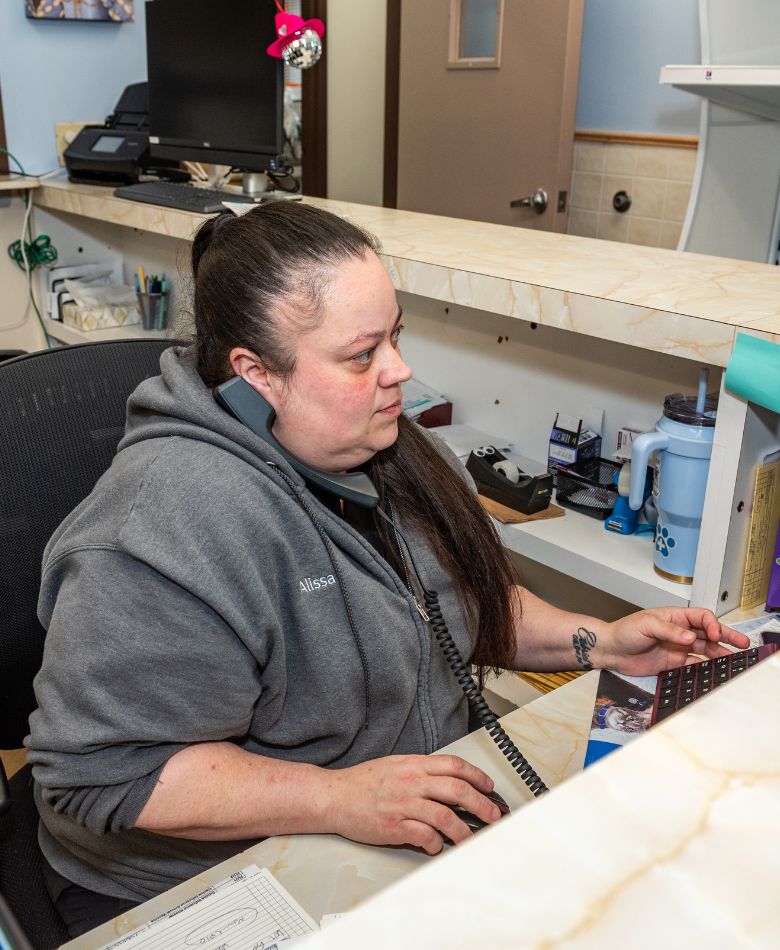 new client form banner (2) vet staff working at front desk